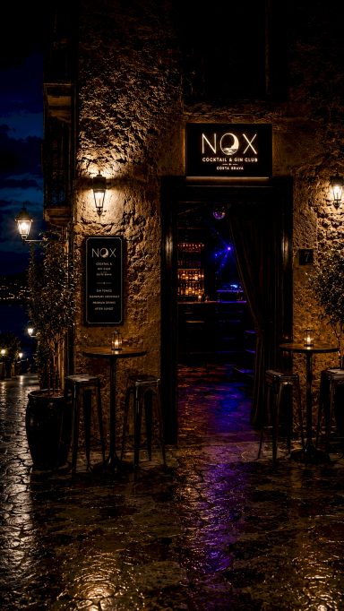 Fotografia professional de local nocturn Fotografia professional d’un local nocturn amb façana de pedra, il·luminació ambiental i entrada elegant per a restaurants, bars i espais d’